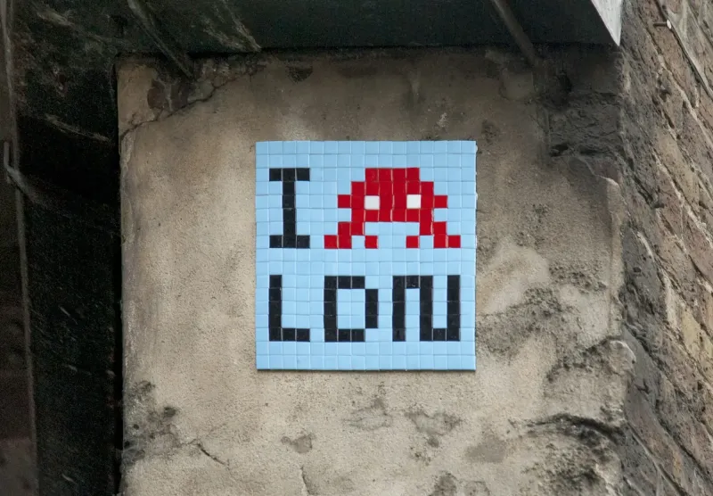 Invader tile mosaic on a London wall reading I [space invader] LON